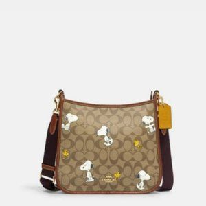 Coach Outlet Coach X Peanuts Dempsey File Bag In Signature Canvas With Snoopy